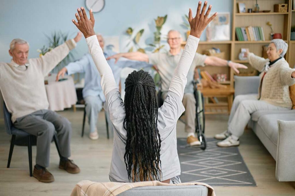 Older adult and family member reviewing care options at a table with notes and a floor plan.