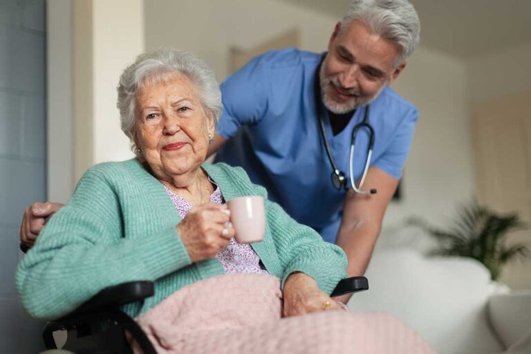 Several older adults sorting and packing household items into cardboard boxes in a bright living room.