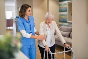 Older adults share a meal and conversation in a bright assisted living community dining room.